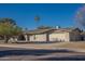 Single-story home with attached two-car garage and desert landscaping at 6630 E Dreyfus Ave, Scottsdale, AZ 85254