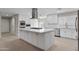 Renovated kitchen featuring white cabinets, quartz countertops, and a large island at 6630 E Dreyfus Ave, Scottsdale, AZ 85254