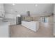 Modern kitchen with white cabinets, a large island, and stainless steel appliances at 6630 E Dreyfus Ave, Scottsdale, AZ 85254