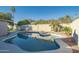 Freeform swimming pool with ample space for relaxation in the backyard at 6630 E Dreyfus Ave, Scottsdale, AZ 85254