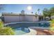 Inviting kidney-shaped pool with a spa, surrounded by rock landscaping at 6630 E Dreyfus Ave, Scottsdale, AZ 85254