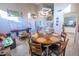 Bright dining area with a round wooden table and six chairs at 6811 W Monona Dr, Glendale, AZ 85308