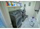 Laundry room with washer, dryer, and storage shelves at 6811 W Monona Dr, Glendale, AZ 85308