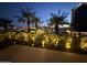 Night view of city skyline from a patio with palm trees and landscape lighting at 7137 E Rancho Vista Dr # 4011, Scottsdale, AZ 85251