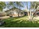 Spacious backyard with grassy area, hanging chair, and partial home view at 7245 E Cambridge Ave, Scottsdale, AZ 85257