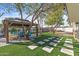 Landscaped backyard with gazebo, fire pit, and artificial turf at 7245 E Cambridge Ave, Scottsdale, AZ 85257