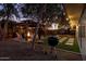 Evening view of backyard with fire pit, gazebo, and string lights at 7245 E Cambridge Ave, Scottsdale, AZ 85257