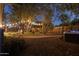 Landscaped backyard at night with hot tub and pathway at 7245 E Cambridge Ave, Scottsdale, AZ 85257