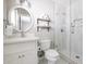 Clean bathroom with white vanity, large mirror, and a walk-in shower at 7245 E Cambridge Ave, Scottsdale, AZ 85257