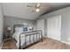 Bedroom with metal bed frame, wood floors, and double doors at 7245 E Cambridge Ave, Scottsdale, AZ 85257