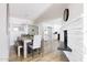 Bright dining area with a farmhouse table, bench seating, and a fireplace feature at 7245 E Cambridge Ave, Scottsdale, AZ 85257