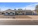 Charming single story home with gray garage door and gravel driveway at 7245 E Cambridge Ave, Scottsdale, AZ 85257