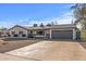 Cute ranch home with gray garage door and well-maintained landscaping at 7245 E Cambridge Ave, Scottsdale, AZ 85257