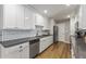 Renovated kitchen featuring white cabinets, stainless steel appliances, and a farmhouse sink at 7245 E Cambridge Ave, Scottsdale, AZ 85257