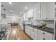 Bright kitchen with white shaker cabinets, quartz countertops and hardwood floors at 7245 E Cambridge Ave, Scottsdale, AZ 85257