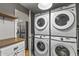 Bright laundry room, featuring a stackable washer and dryer, and ample counter space at 7245 E Cambridge Ave, Scottsdale, AZ 85257