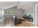 Cozy living room with grey sofa, ceiling fan, and hardwood floors at 7245 E Cambridge Ave, Scottsdale, AZ 85257