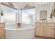 Bathroom features a large corner tub and light wood vanity at 7297 E Black Rock Rd, Scottsdale, AZ 85255