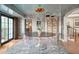 Stylish dining room with a round table and transparent chairs, near a staircase at 7348 N Red Ledge Dr, Paradise Valley, AZ 85253