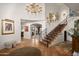 Elegant entryway with a grand staircase and tile floors at 7348 N Red Ledge Dr, Paradise Valley, AZ 85253