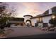 Stunning home exterior with a charming arched entryway at 7348 N Red Ledge Dr, Paradise Valley, AZ 85253