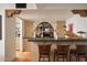 Modern home bar with dark countertop and stylish woven barstools at 7348 N Red Ledge Dr, Paradise Valley, AZ 85253