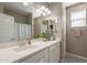 Single vanity bathroom with shower and linen storage at 7950 S 45Th Ave, Laveen, AZ 85339