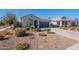 One-story home with gray exterior, two-car garage, and well-maintained landscaping at 7950 S 45Th Ave, Laveen, AZ 85339