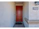 Red front door with a welcome mat and house number 7950 at 7950 S 45Th Ave, Laveen, AZ 85339