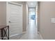 Clean hallway with tile floor, white doors, and modern light fixtures at 7950 S 45Th Ave, Laveen, AZ 85339