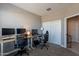 Home office with two monitors, keyboard, and chair at 7950 S 45Th Ave, Laveen, AZ 85339