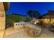 Landscaped backyard with a built-in grill and seating area at 8531 E Twisted Leaf Dr, Gold Canyon, AZ 85118