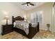 Bright bedroom with a dark wood bed frame and tiled floors at 8531 E Twisted Leaf Dr, Gold Canyon, AZ 85118