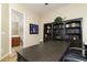 Bright home office with desk, built-in shelving, and bathroom access at 8531 E Twisted Leaf Dr, Gold Canyon, AZ 85118