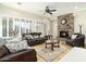 Living room with stone fireplace, leather furniture, and large windows at 8531 E Twisted Leaf Dr, Gold Canyon, AZ 85118