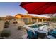 Inviting backyard oasis with a sparkling pool, fire pit, and seating at 8531 E Twisted Leaf Dr, Gold Canyon, AZ 85118