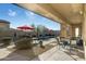 Relaxing pool area with patio furniture and red umbrella at 8531 E Twisted Leaf Dr, Gold Canyon, AZ 85118