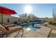 Relaxing pool area with lounge chairs and multiple umbrellas at 8531 E Twisted Leaf Dr, Gold Canyon, AZ 85118