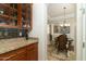 Wet bar with granite countertop, cabinets, and wine rack at 8531 E Twisted Leaf Dr, Gold Canyon, AZ 85118