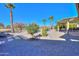 Spacious backyard with gravel, palm trees and patio at 9 N Agua Fria Ln, Casa Grande, AZ 85194