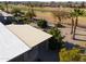 Desert landscaping with patio cover, mature palm trees, and golf course views at 9 N Agua Fria Ln, Casa Grande, AZ 85194