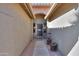 Brick entryway with arched walkway and security door at 9 N Agua Fria Ln, Casa Grande, AZ 85194