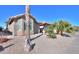 House exterior with stone accents and palm trees at 9 N Agua Fria Ln, Casa Grande, AZ 85194