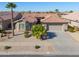 Single-story home with tile roof, two-car garage, and desert landscaping at 9 N Agua Fria Ln, Casa Grande, AZ 85194