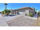 Tan house with a two-car garage and driveway at 9 N Agua Fria Ln, Casa Grande, AZ 85194