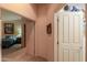 Hallway with carpet flooring and doors to bedrooms at 9 N Agua Fria Ln, Casa Grande, AZ 85194