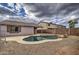 Relaxing kidney-shaped pool with pebble tec finish in backyard at 9909 W Miami St, Tolleson, AZ 85353