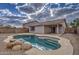 Stunning kidney-shaped pool with a rock waterfall feature at 9909 W Miami St, Tolleson, AZ 85353