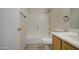 Clean bathroom with a bathtub, toilet and wood vanity at 9909 W Miami St, Tolleson, AZ 85353