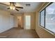 Bright bedroom with ceiling fan and pool view at 9909 W Miami St, Tolleson, AZ 85353